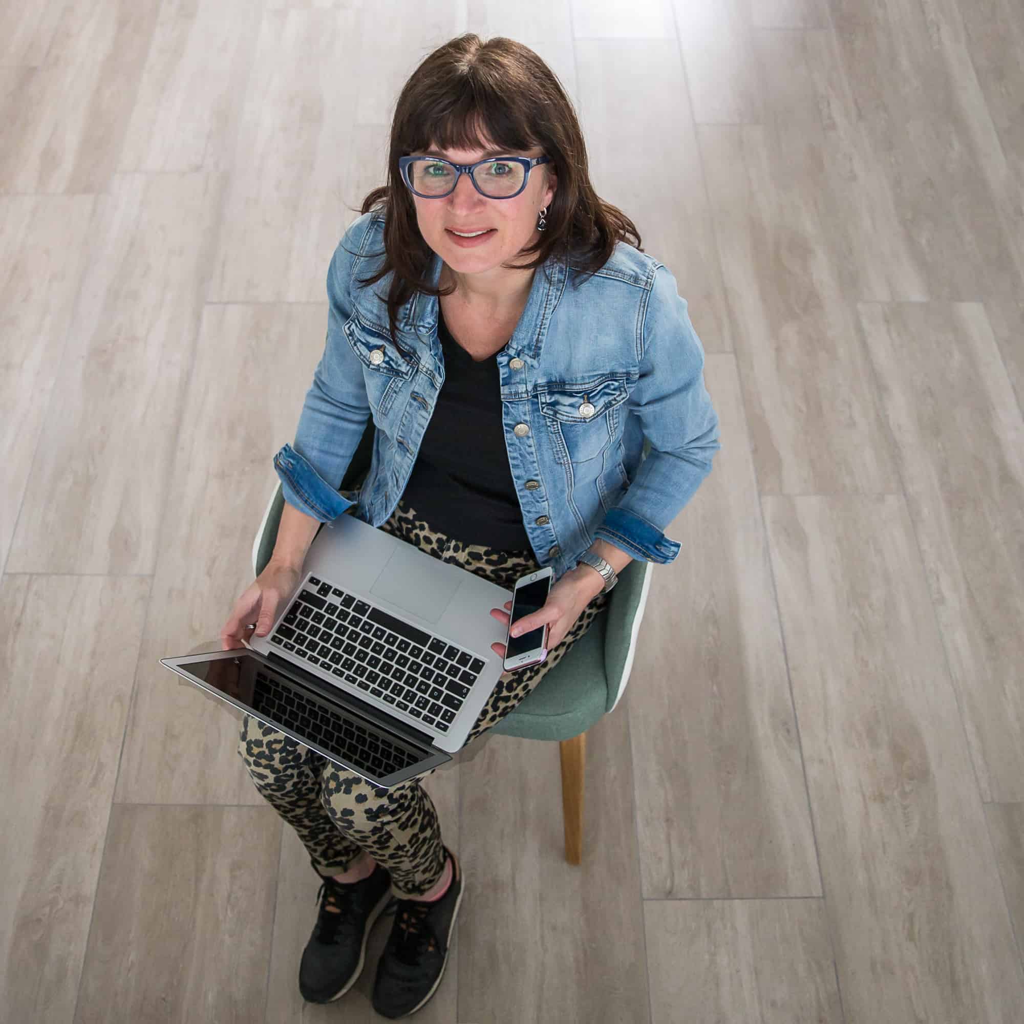 Foto van Marja Verheijen, van bovenaf, zittend op een stoel met een laptop, op de Homepage bij Plannen van mavadvieseninterim.nl